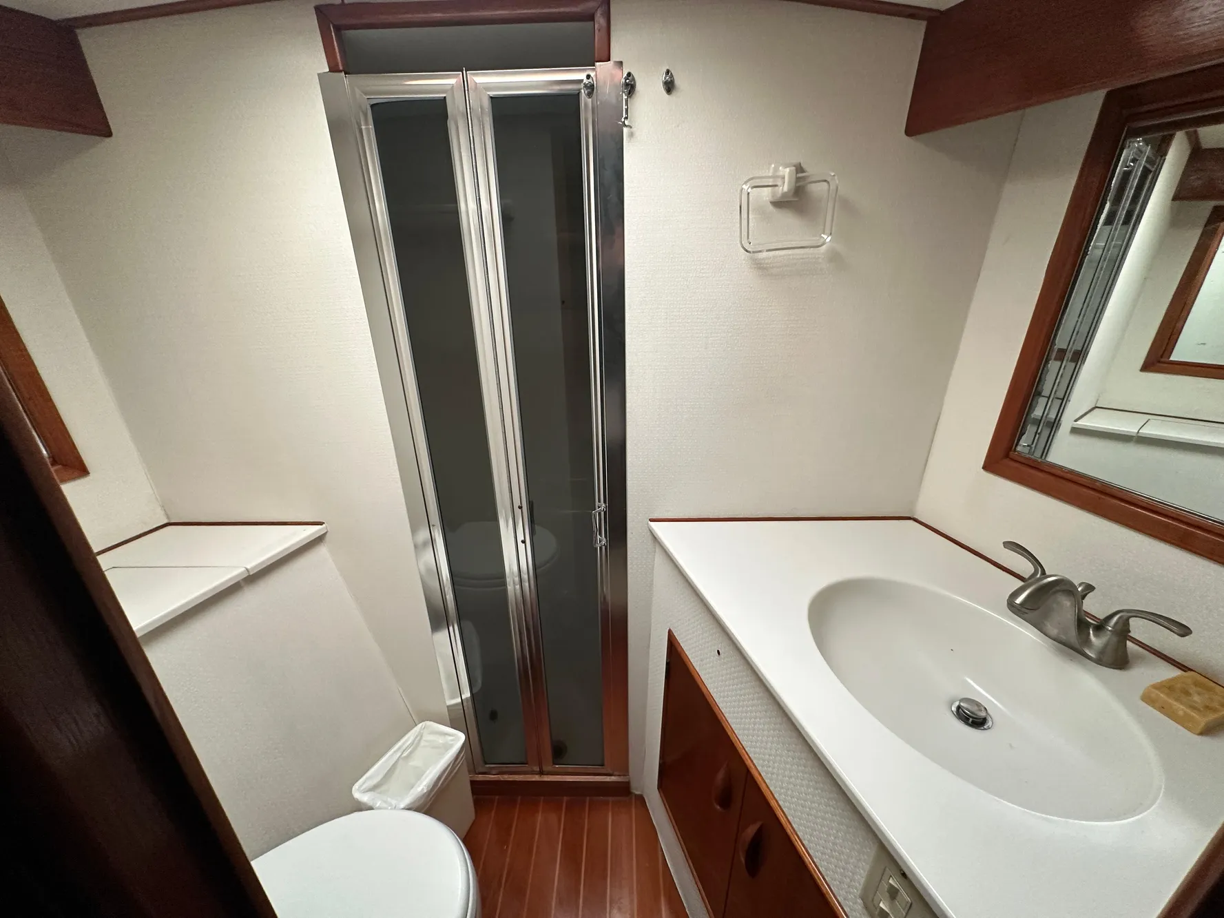 1988 Buddy Davis Convertible yacht bathroom with shower, sink, and wooden accents.
