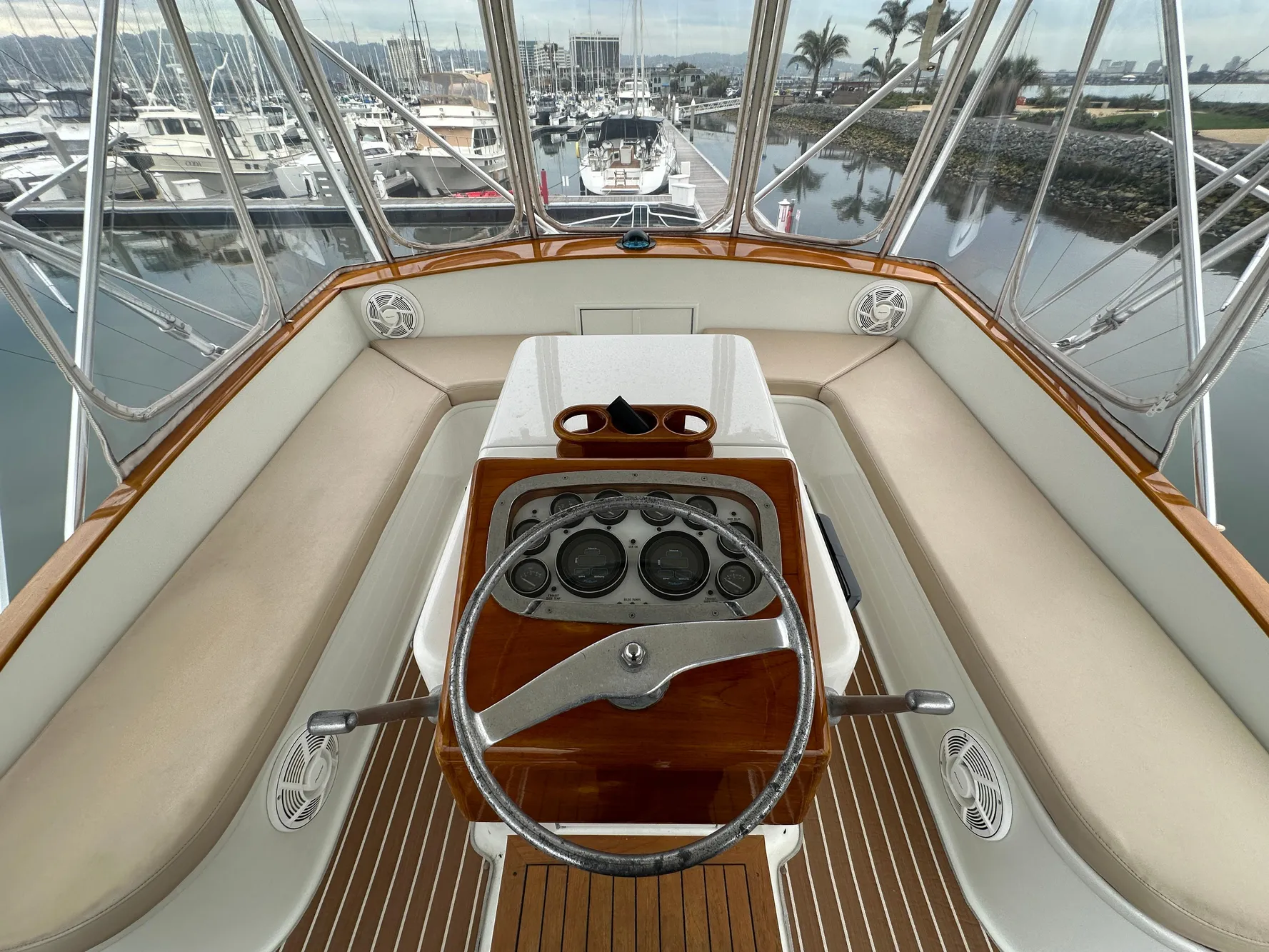 1988 Buddy Davis Convertible yacht helm with wooden dashboard and marina view.