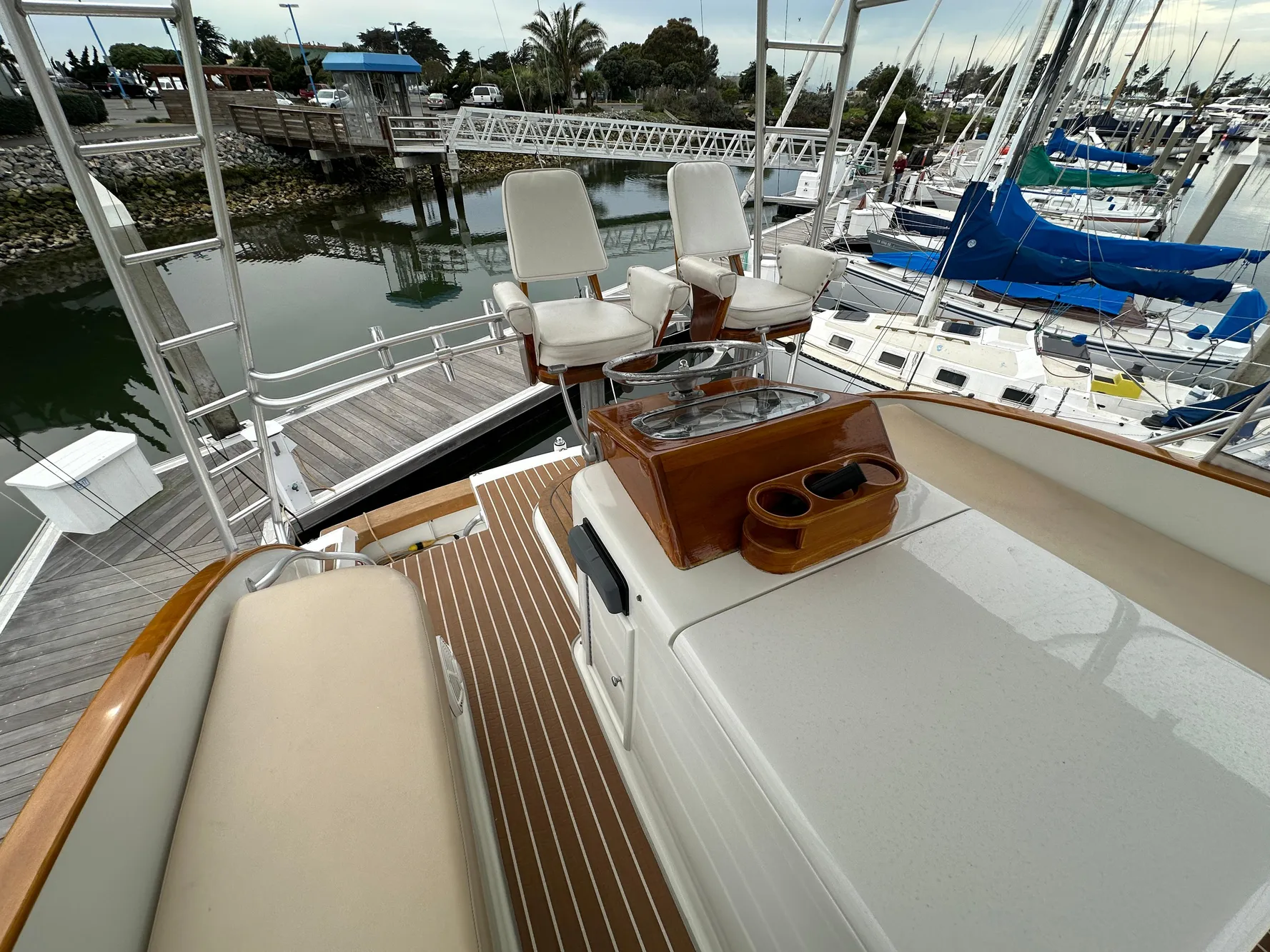 1988 Buddy Davis Convertible yacht with seating and helm, docked at a marina.