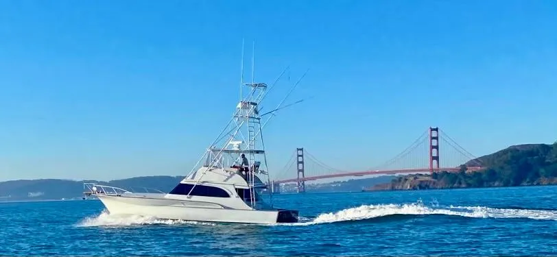1988 Buddy Davis Convertible yacht cruising near Golden Gate Bridge on a sunny day.