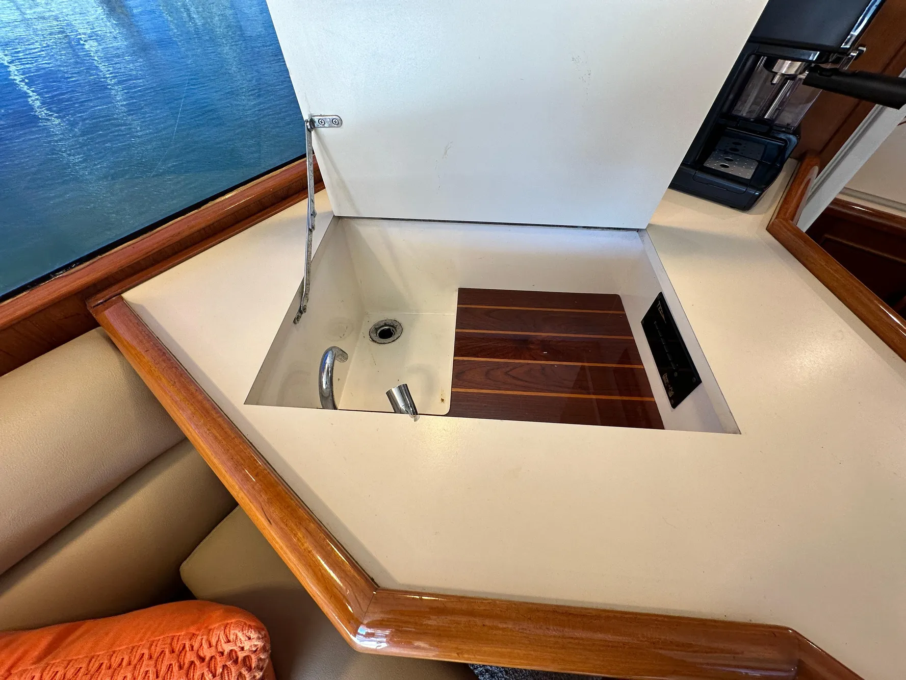1988 Buddy Davis Convertible yacht interior with built-in sink and wooden accents.