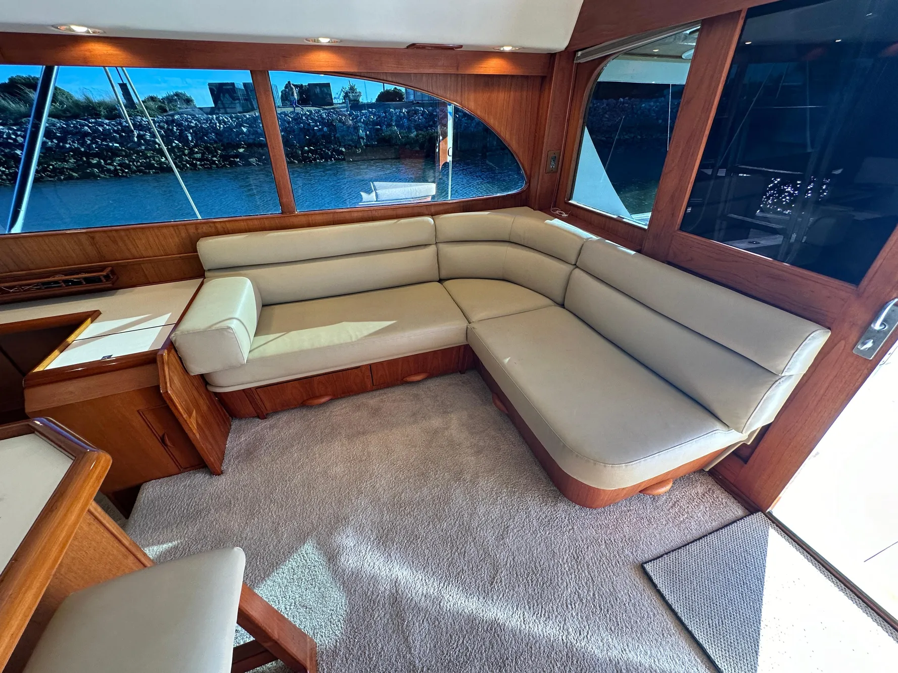 Luxurious interior of a 1988 Buddy Davis Convertible yacht with plush seating and large windows.