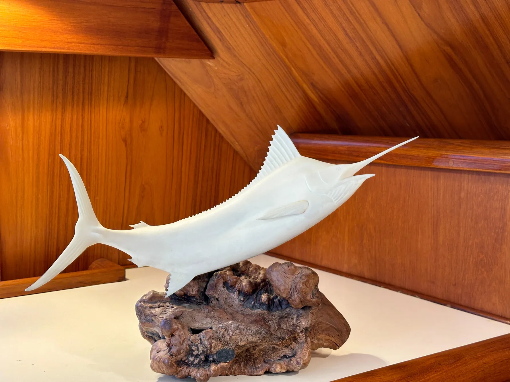 Decorative marlin sculpture on wooden base inside 1988 Buddy Davis Convertible yacht.