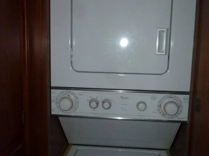 The Bottom Line Yacht Photos Pics Stacked washer and dryer inside 1987 Hatteras Flybridge yacht.