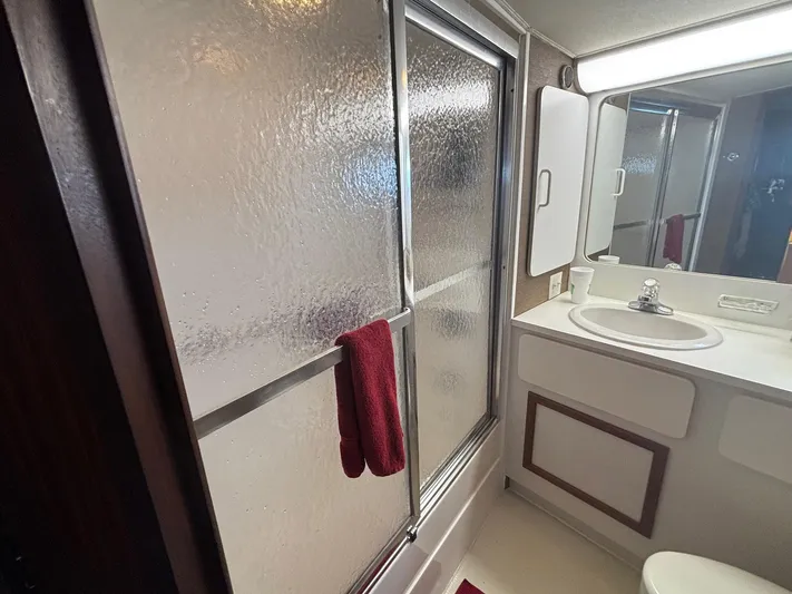 The Bottom Line Yacht Photos Pics Bathroom interior of 1987 Hatteras Flybridge yacht with shower and sink.