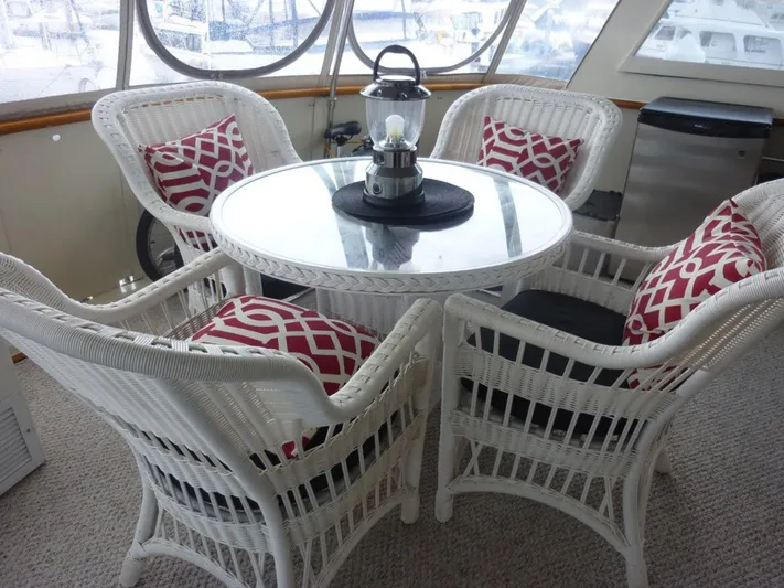 The Bottom Line Yacht Photos Pics White wicker furniture with red cushions on a 1987 Hatteras Flybridge yacht.