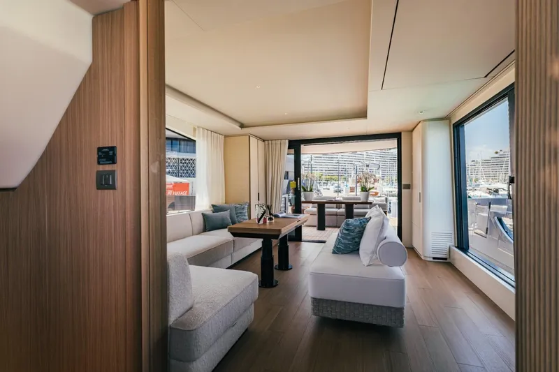  Yacht Photos Pics Luxurious interior of 2025 Azimut Seadeck 7 yacht with modern furnishings and marina view.