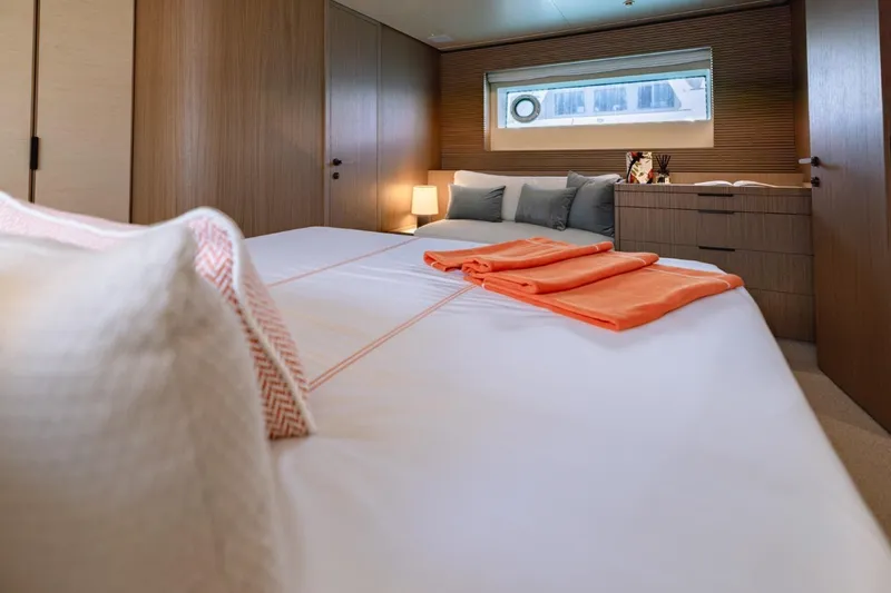  Yacht Photos Pics Luxurious bedroom interior of 2025 Azimut Seadeck 7 yacht with modern design and cozy ambiance.