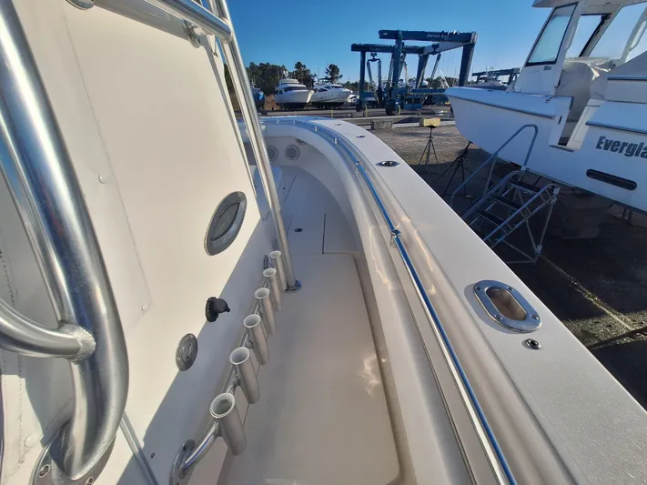 Salt Break Yacht Photos Pics 2020 Contender 32T boat deck with rod holders and railings, docked at marina.