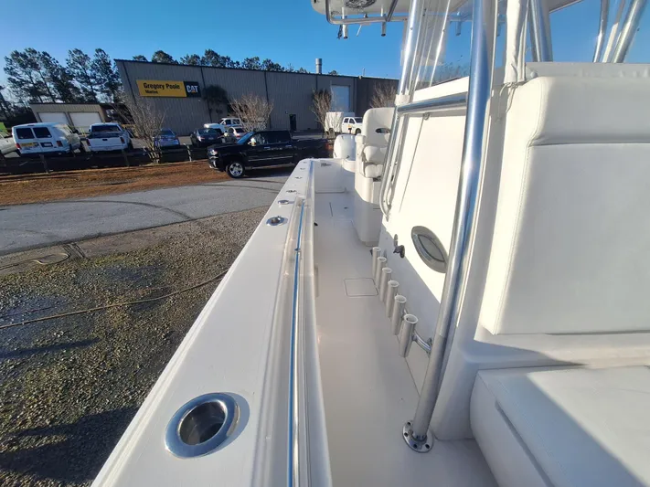Salt Break Yacht Photos Pics 2020 Contender 32T boat interior with rod holders and seating, parked near a dealership.