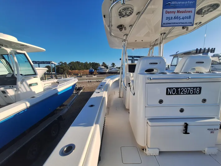 Salt Break Yacht Photos Pics 2020 Contender 32T boat docked, featuring sleek design and modern amenities under clear blue sky.