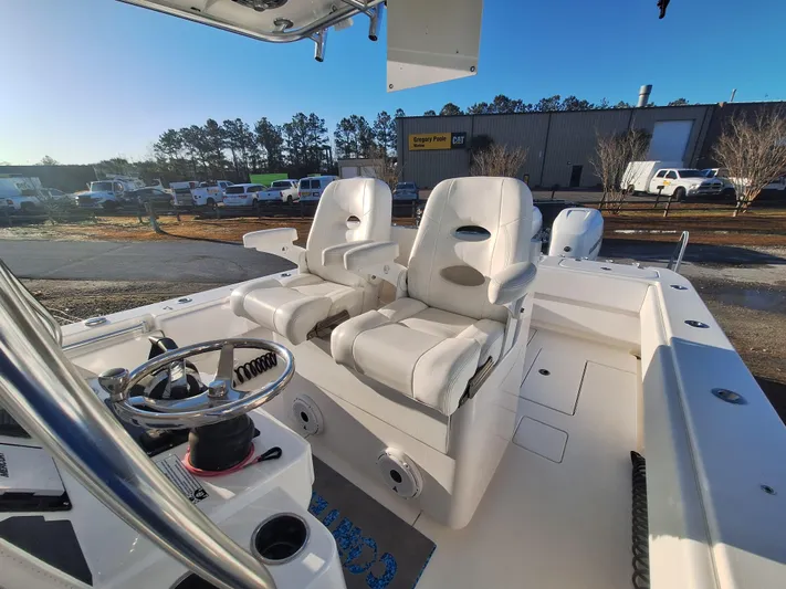 Salt Break Yacht Photos Pics 2020 Contender 32T boat interior with dual white captain's chairs and steering wheel.