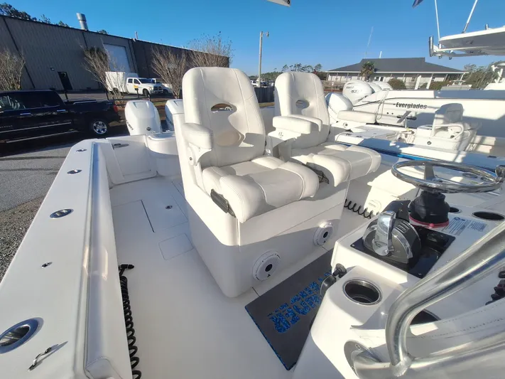 Salt Break Yacht Photos Pics 2020 Contender 32T boat interior with dual white captain's chairs and steering console.