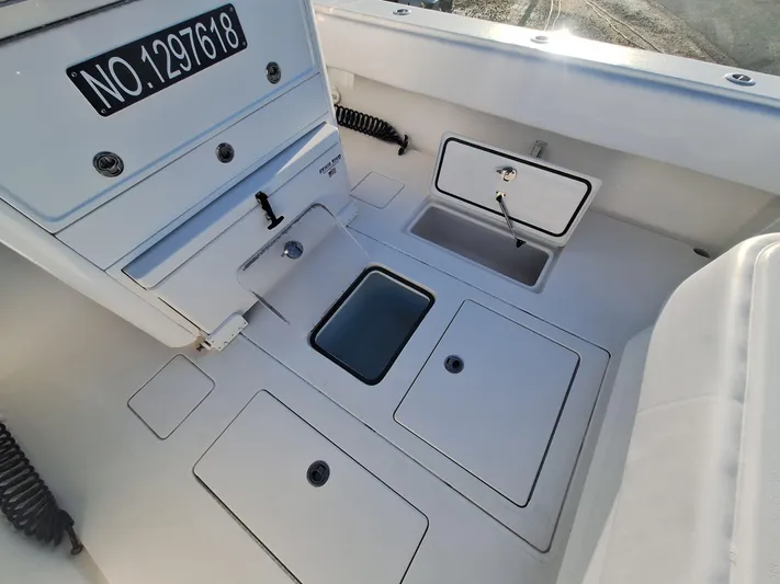 Salt Break Yacht Photos Pics 2020 Contender 32T boat deck with storage compartments and registration number.