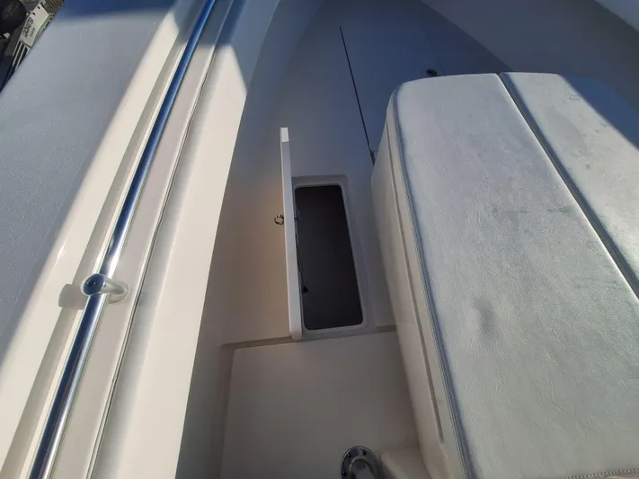Salt Break Yacht Photos Pics 2020 Contender 32T boat interior with open storage compartment and cushioned seating.