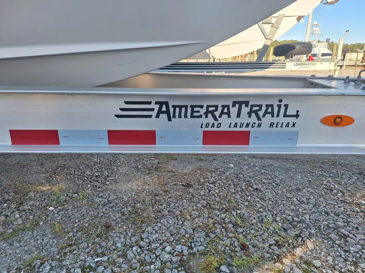 Salt Break Yacht Photos Pics Trailer with AmeraTrail branding, featuring "Load Launch Relax" slogan, on gravel surface.
