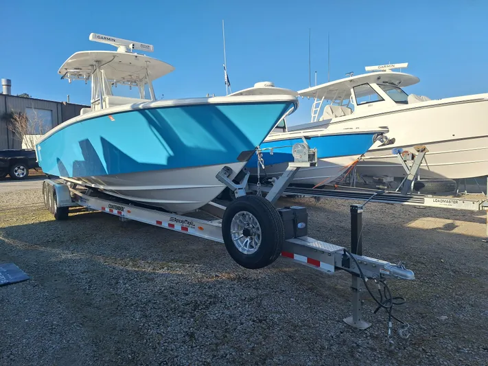 Salt Break Yacht Photos Pics 2020 Contender 32T boat on trailer, vibrant blue hull, parked outdoors.