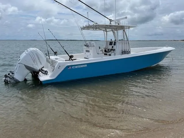 Salt Break Yacht Photos Pics 2020 Contender 32T boat in shallow water, featuring fishing rods and dual outboard engines.