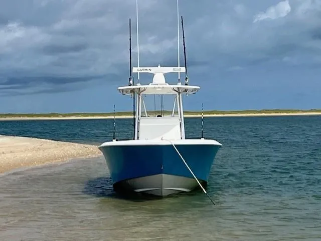 Salt Break Yacht Photos Pics 2020 Contender 32T boat anchored on a sandy beach with cloudy skies.