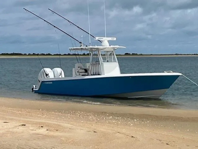 Salt Break Yacht Photos Pics 2020 Contender 32T boat anchored on sandy shore with fishing rods.