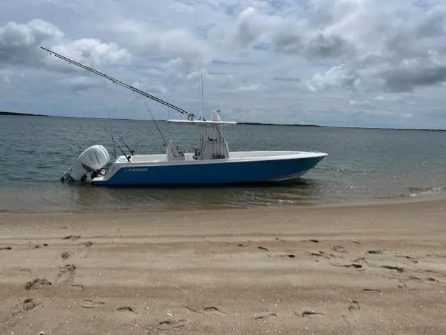 Salt Break Yacht Photos Pics 2020 Contender 32T boat on sandy beach under cloudy sky.