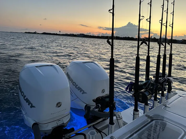 Salt Break Yacht Photos Pics 2020 Contender 32T boat with Mercury engines and fishing rods at sunset on the water.