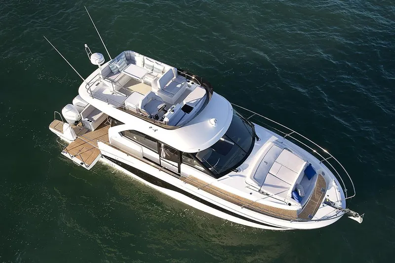 On Order Yacht Photos Pics Manufacturer Provided Image: 2025 Beneteau Antares 12 Fly yacht cruising on open water, aerial view.