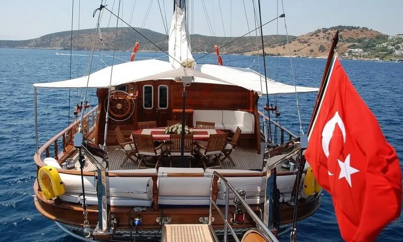  Yacht Photos Pics Custom 2009 motorsailor with Turkish flag, wooden deck, and seating area on blue sea.