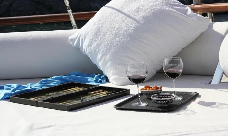  Yacht Photos Pics Luxurious yacht deck with wine glasses, snacks, and a cozy pillow, 2009 Custom Made Motorsailor.