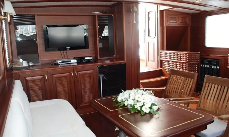  Yacht Photos Pics Luxurious 2009 custom-made motorsailor interior with wood finish, TV, and elegant seating area.