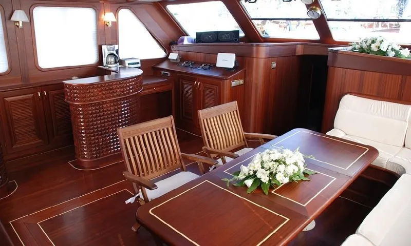  Yacht Photos Pics Luxurious interior of 2009 Custom Made Motorsailor with elegant wooden furnishings and floral centerpiece.