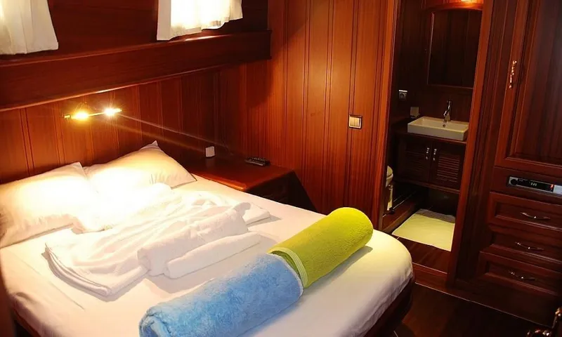  Yacht Photos Pics Luxurious cabin interior of 2009 Custom Made Motorsailor with cozy bed and ensuite bathroom.