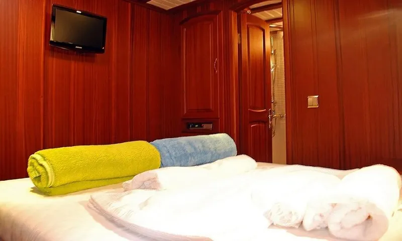  Yacht Photos Pics Luxurious cabin interior of 2009 Custom Made Motorsailor with wooden walls and rolled towels.