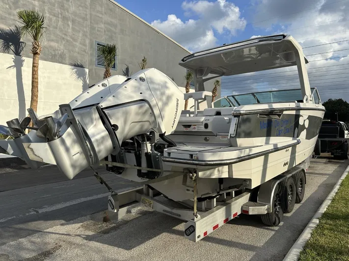  Yacht Photos Pics 2020 Aviara AV32 OB boat on trailer, parked outdoors, with dual outboard engines.