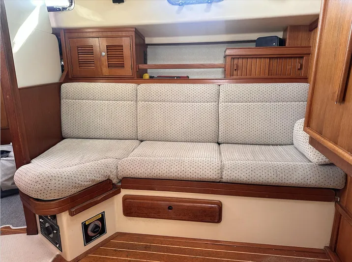 Next Course Yacht Photos Pics 2001 Island Packet 320 interior with cushioned seating and wooden cabinetry.