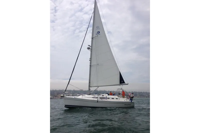 Mary Anne Yacht Photos Pics 2009 Hunter 38 sailboat on open water under cloudy sky.