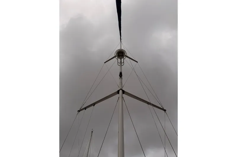Mary Anne Yacht Photos Pics Mast of 2009 Hunter 38 sailboat against cloudy sky.
