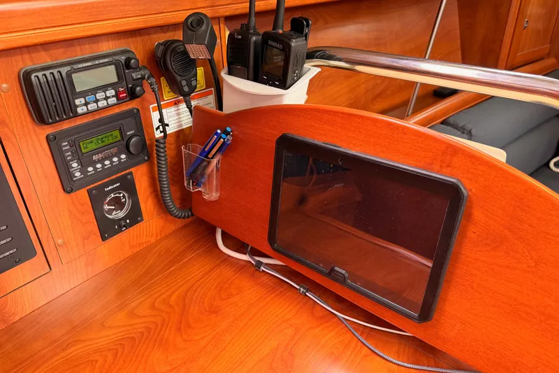 Mary Anne Yacht Photos Pics Navigation station on a 2009 Hunter 38 sailboat with communication equipment and tablet holder.