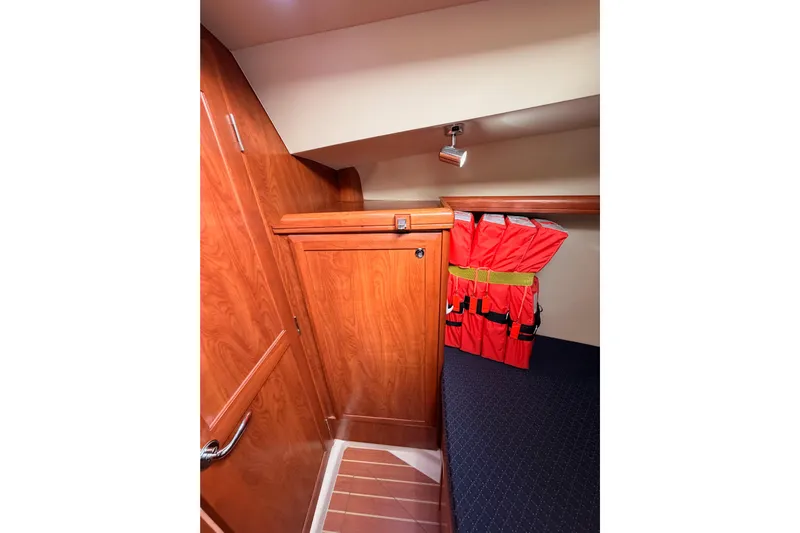 Mary Anne Yacht Photos Pics Interior of 2009 Hunter 38 sailboat with wooden cabinetry and life jackets.