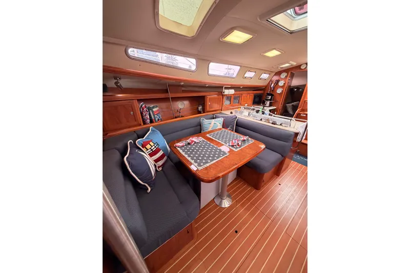 Mary Anne Yacht Photos Pics Luxurious interior of 2009 Hunter 38 sailboat with cozy seating and elegant wood finishes.