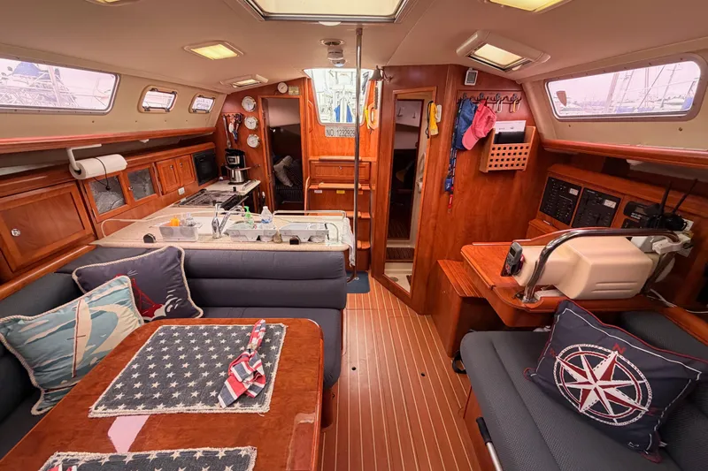 Mary Anne Yacht Photos Pics Interior of 2009 Hunter 38 sailboat with cozy seating, kitchen, and nautical decor.