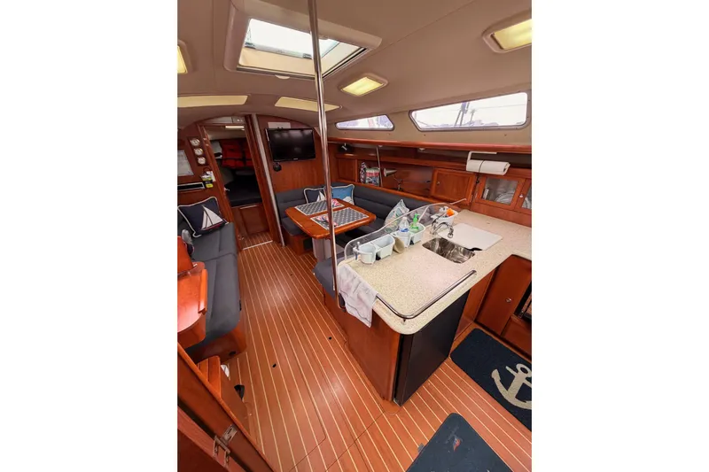 Mary Anne Yacht Photos Pics Interior of 2009 Hunter 38 sailboat with wood flooring and modern amenities.