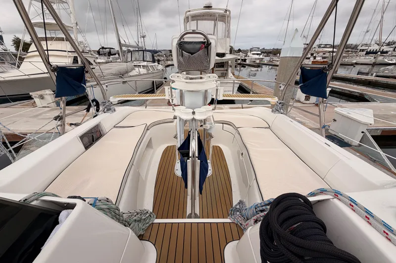 Mary Anne Yacht Photos Pics 2009 Hunter 38 sailboat with teak deck, docked in a marina under cloudy skies.