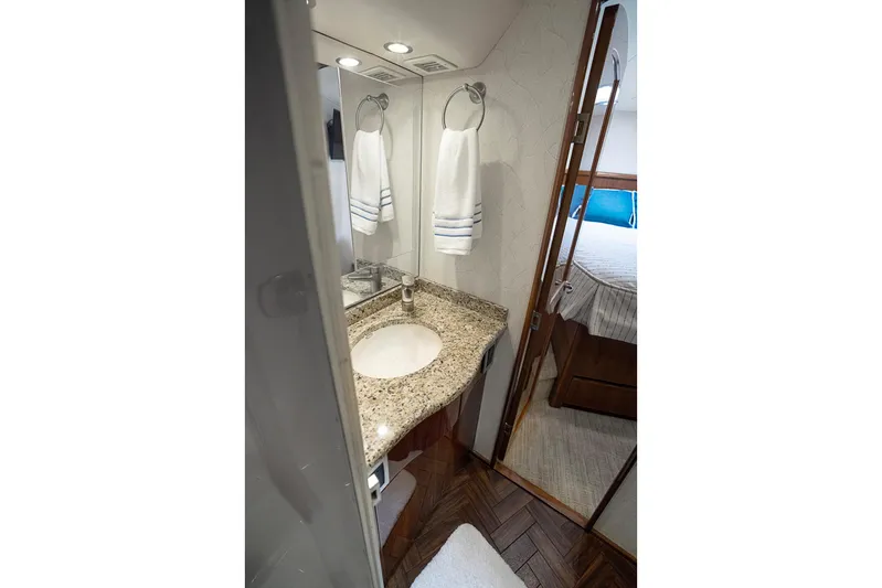 Serenity Now Yacht Photos Pics Luxurious bathroom in 2014 Viking 66 yacht with granite countertop and elegant fixtures.