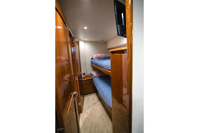 Serenity Now Yacht Photos Pics Luxurious 2014 Viking 66 yacht cabin with wooden interior and bunk beds.