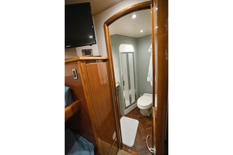 Serenity Now Yacht Photos Pics Luxurious bathroom in 2014 Viking 66 yacht with wood accents and modern fixtures.