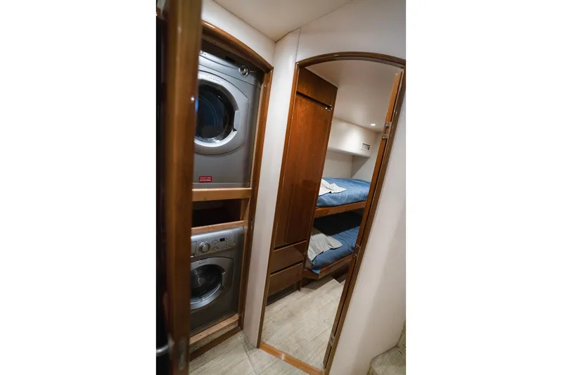 Serenity Now Yacht Photos Pics Laundry area and bunk beds in 2014 Viking 66 yacht interior.