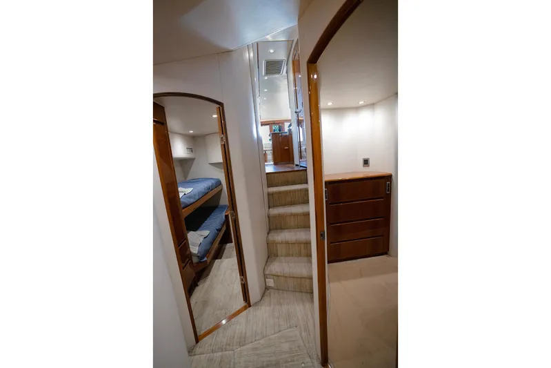 Serenity Now Yacht Photos Pics Interior of 2014 Viking 66 yacht with bunk beds and wooden cabinetry.