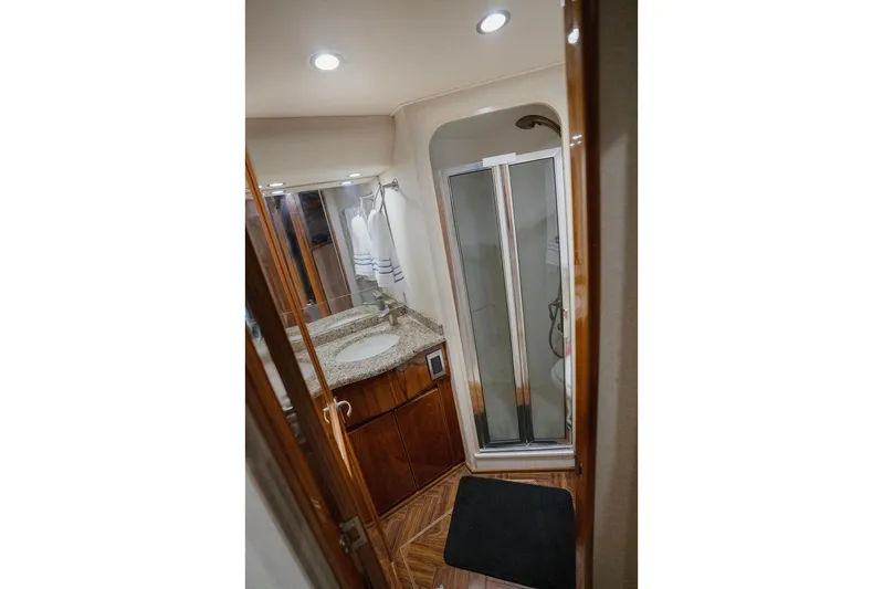 Serenity Now Yacht Photos Pics Luxurious bathroom in 2014 Viking 66 yacht with granite countertop and glass shower.