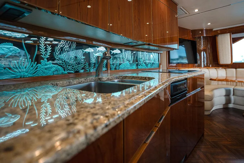 Serenity Now Yacht Photos Pics Luxurious 2014 Viking 66 yacht kitchen with elegant wood cabinetry and ocean-themed decor.
